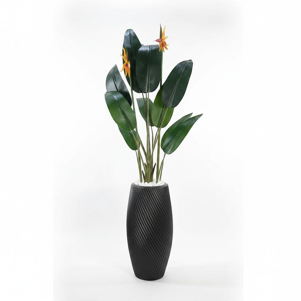 Wadi Home artificial Bird of Paradise plant with lush green leaves and orange flowers in a textured black floor planter