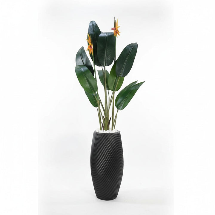 Wadi Home artificial Bird of Paradise plant with lush green leaves and orange flowers in a textured black floor planter