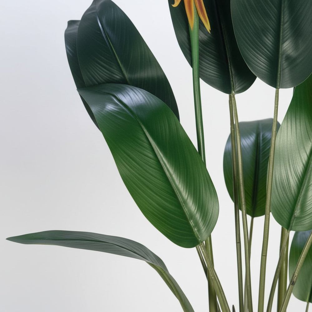 Wadi Home artificial Bird of Paradise plant with lush green leaves and vibrant orange blooms in a modern planter