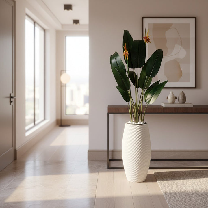 Wadi Home artificial Bird of Paradise plant with vibrant orange blooms in a white spiral textured floor planter.