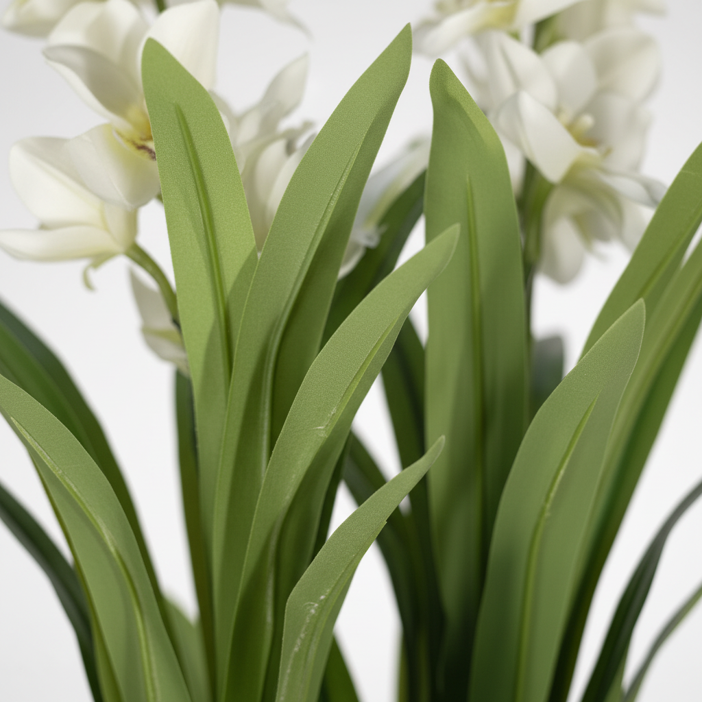 Close-up of Wadi Home artificial dracaena plant with vibrant green leaves and delicate white flowers