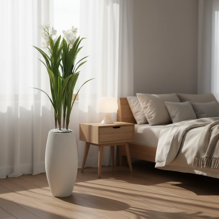 Wadi Home artificial dracaena plant with white flowers in a textured spiral white floor vase in a bright bedroom