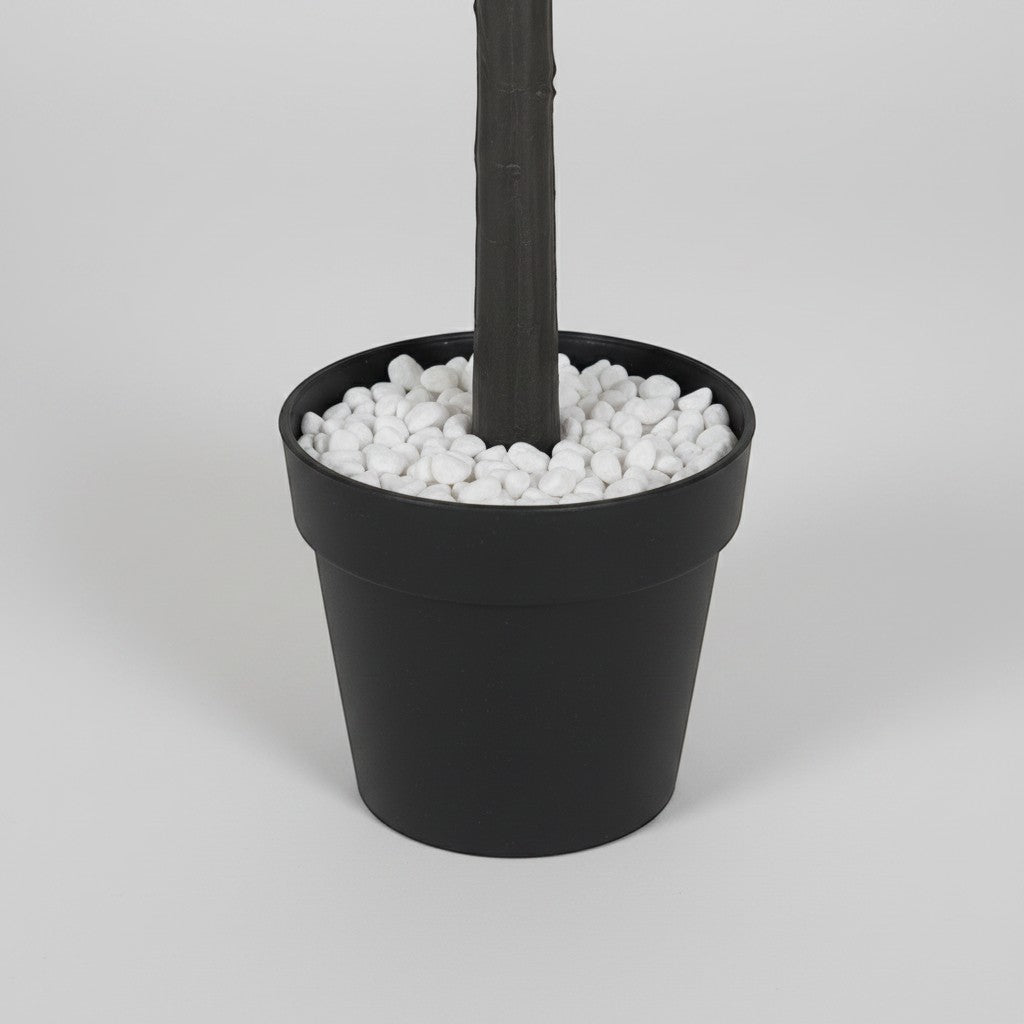 Wadi Home artificial eucalyptus tree in a black pot with decorative white pebbles at the base
