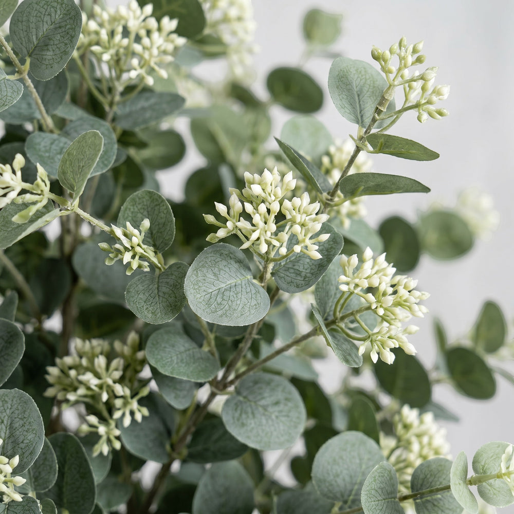 Wadi Home Artificial Eucalyptus Tree with silvery-green leaves and white buds in a textured pot.