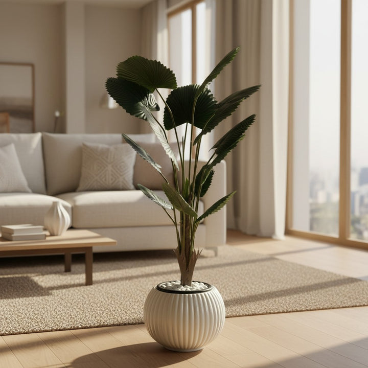Wadi Home artificial fan palm plant with deep green leaves in a modern white ribbed planter on a living room floor.