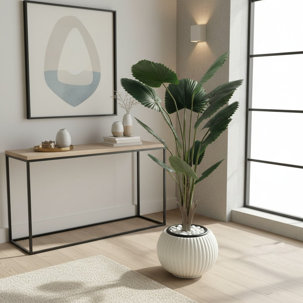 Wadi Home artificial fan palm plant with deep green leaves in a white ribbed ceramic pot on a light wood floor.