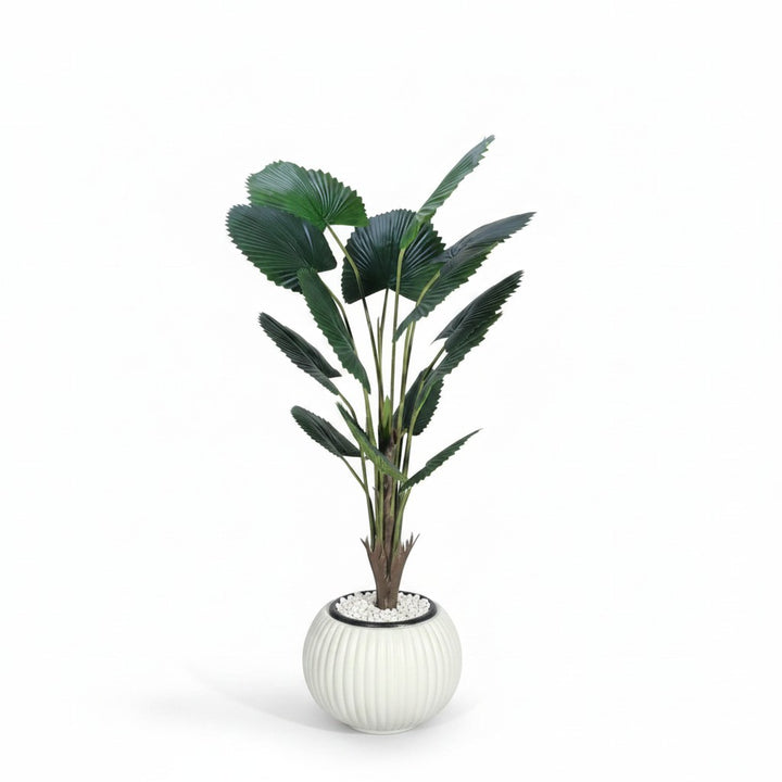 Wadi Home artificial fan palm plant with deep green leaves in a modern white ribbed ceramic pot with white pebbles