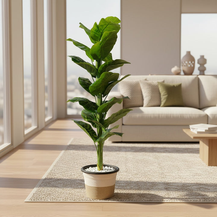 Wadi Home artificial fiddle leaf fig plant with vibrant green leaves in a two-tone textured planter with white stones.