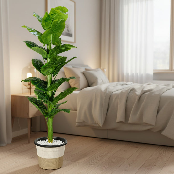 Wadi Home artificial fiddle leaf fig plant with vibrant green leaves in a two-tone textured pot in a bedroom.