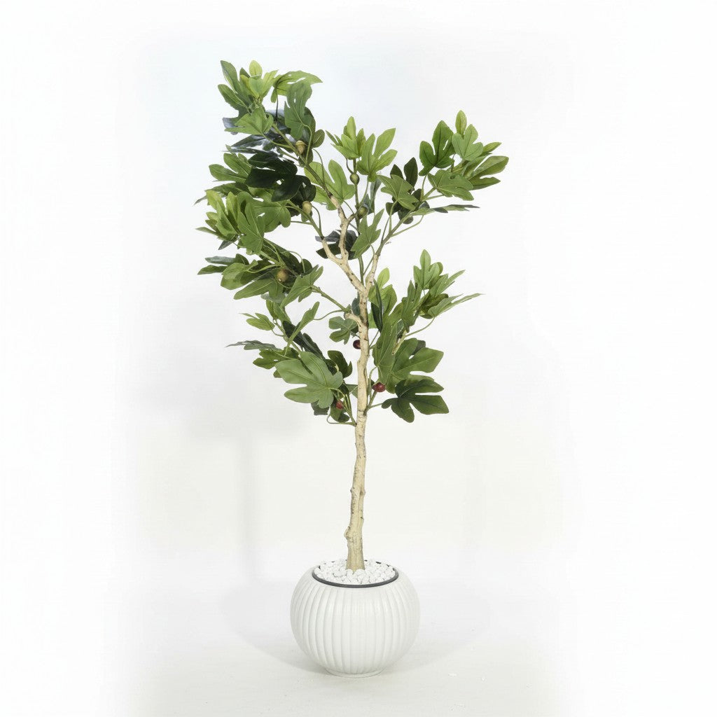 Wadi Home artificial fig tree with lush green leaves and textured trunk in a ribbed white pot with decorative pebbles.