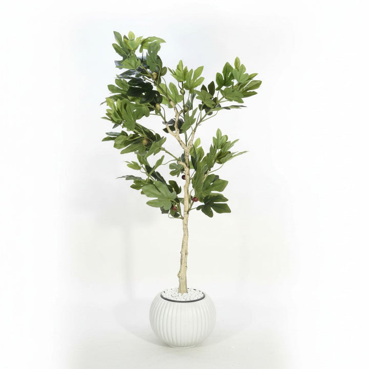 Wadi Home artificial fig tree with lush green leaves and textured trunk in a ribbed white pot with decorative pebbles.