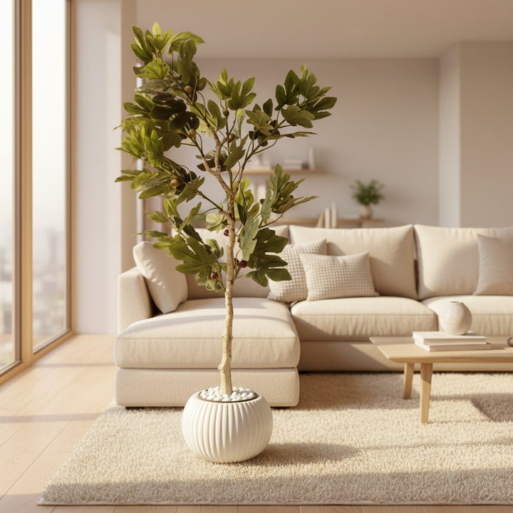Wadi Home artificial fig tree with green foliage and textured trunk in a ribbed white pot on a beige living room rug.