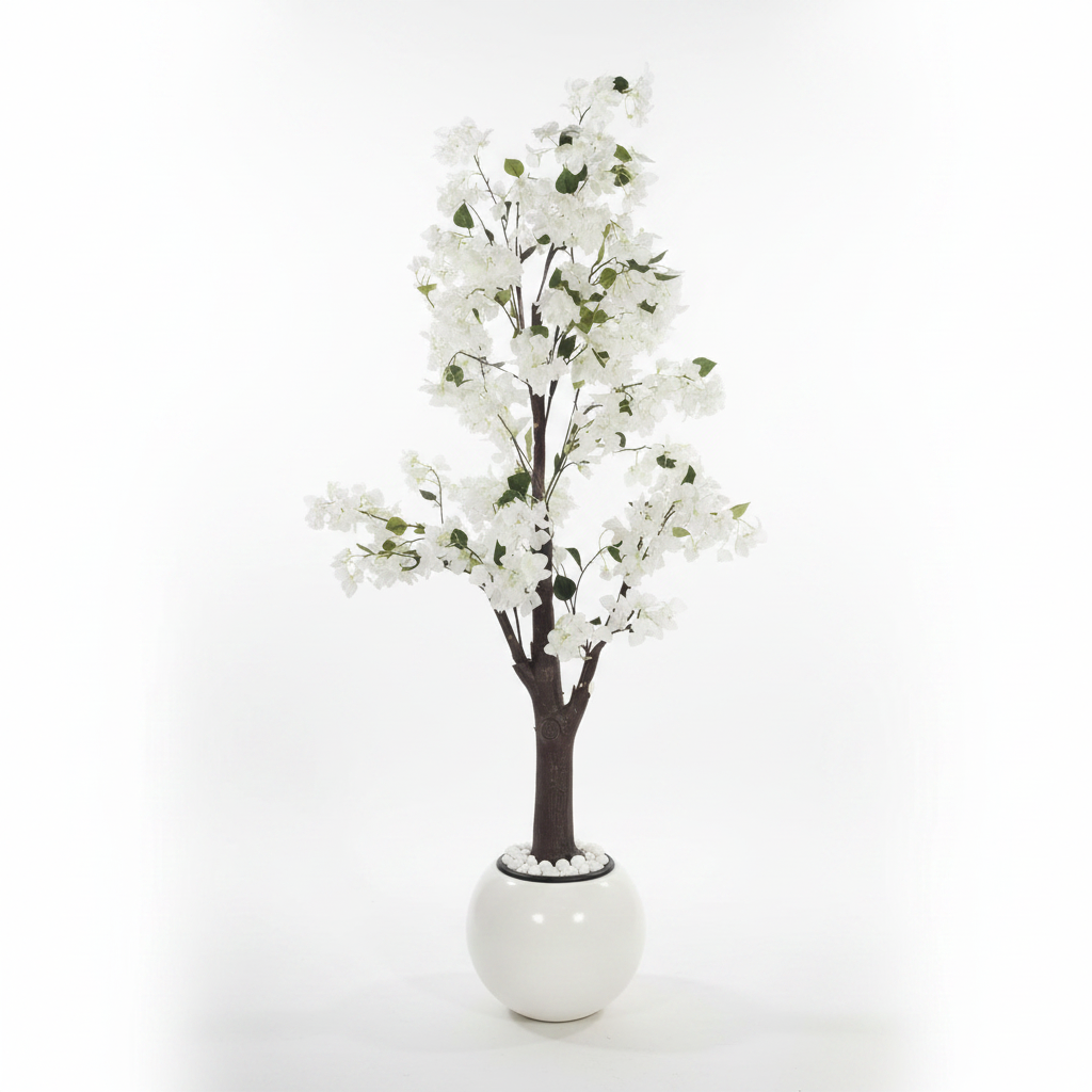 Wadi Home artificial flowering tree with white blossoms and green leaves in a modern white spherical planter.