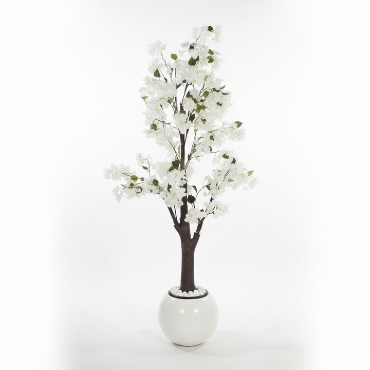 Wadi Home artificial flowering tree with white blossoms and green leaves in a modern white spherical planter.