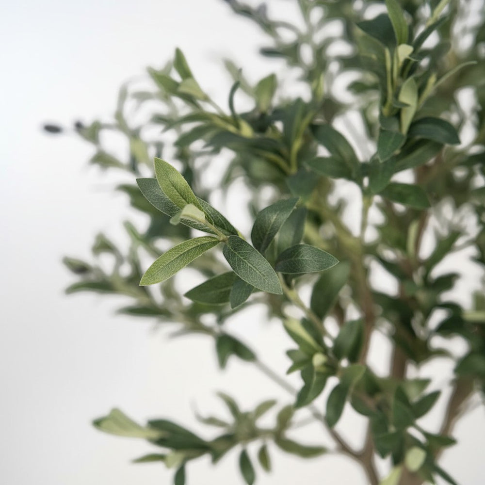 Wadi Home artificial olive tree with realistic dual-toned green leaves and small dark olives on a textured branch