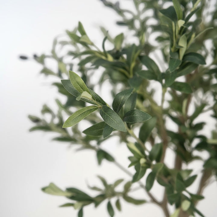 Wadi Home artificial olive tree with realistic dual-toned green leaves and small dark olives on a textured branch