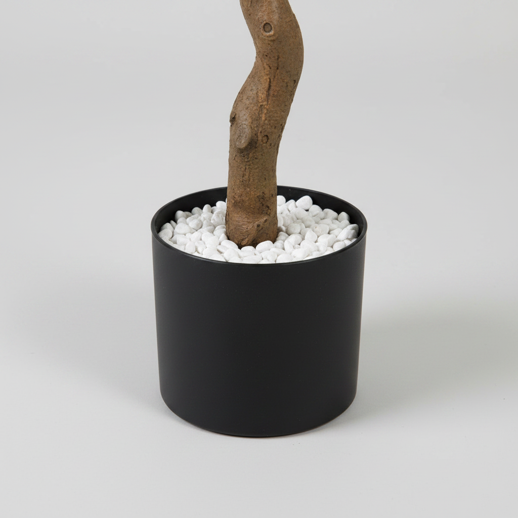 Wadi Home artificial olive tree base with a textured brown trunk in a sleek black pot filled with white stones