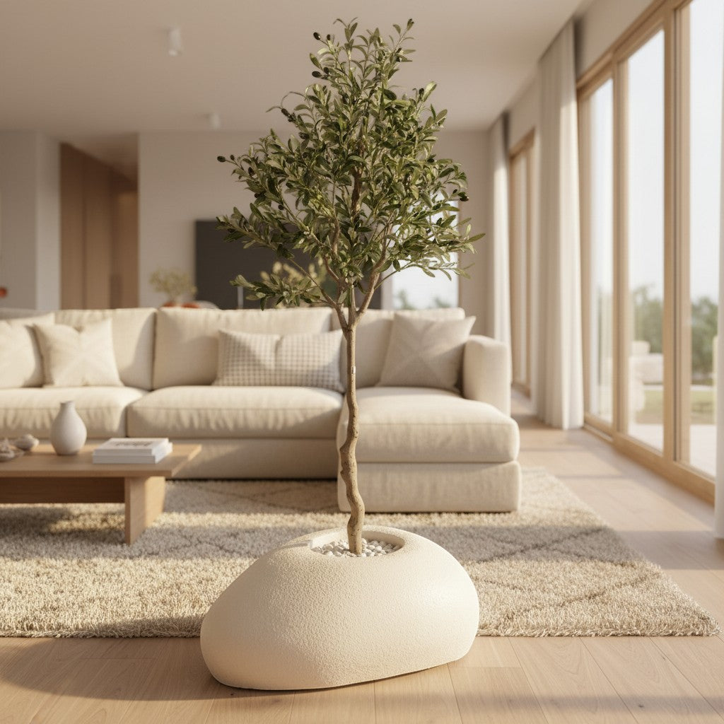 Wadi Home artificial olive tree with realistic green leaves in a unique organic stone planter in a modern living room