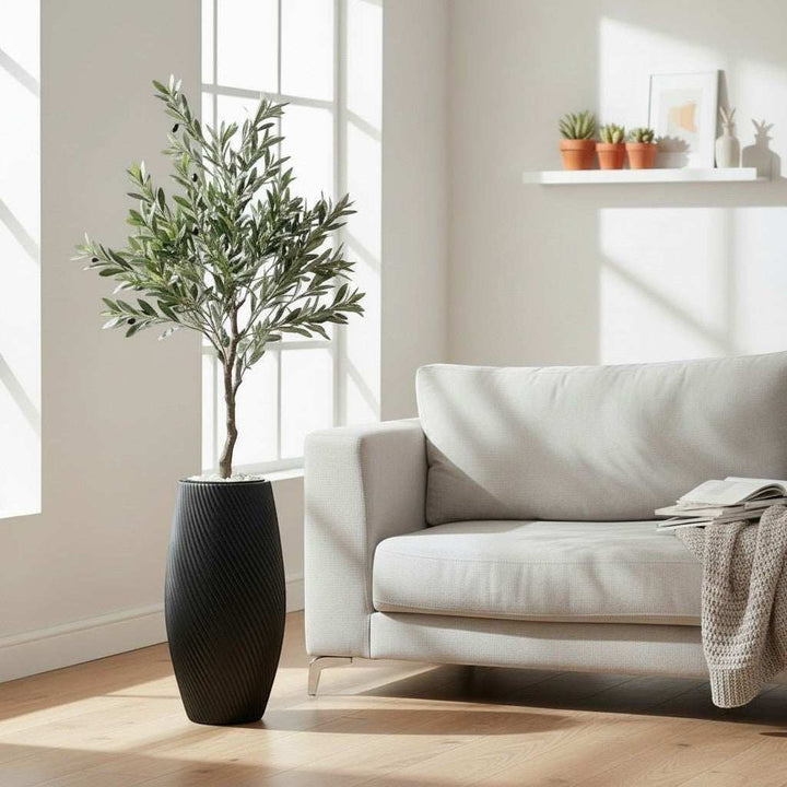 Wadi Home artificial olive tree with green leaves and black olives in a textured black planter.