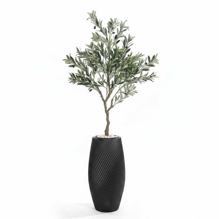 Wadi Home artificial olive tree with green leaves and black olives in a textured black planter with white stones.