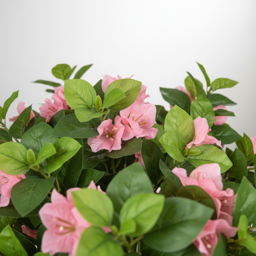 Wadi Home artificial flowering tree with vibrant pink blossoms and lush green leaves in a close-up view
