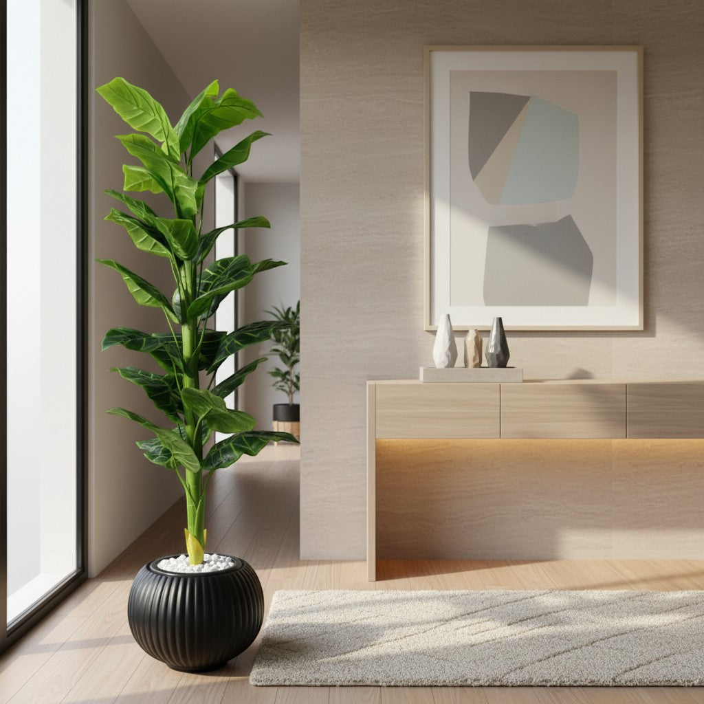 Wadi Home artificial floor plant with vibrant green leaves in a ribbed black pot with white stones in a modern room.