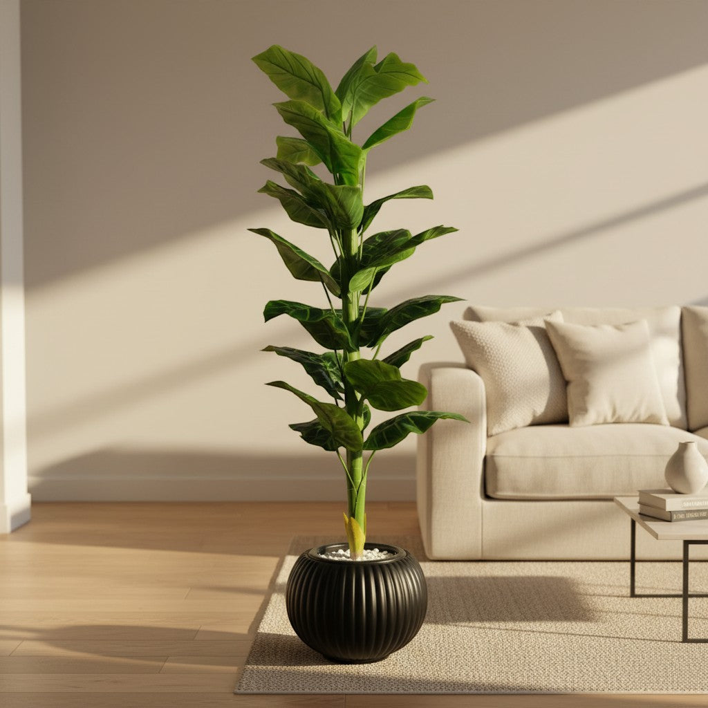 Wadi Home tall artificial indoor floor plant with vibrant green leaves in a ribbed black pot with white stone base
