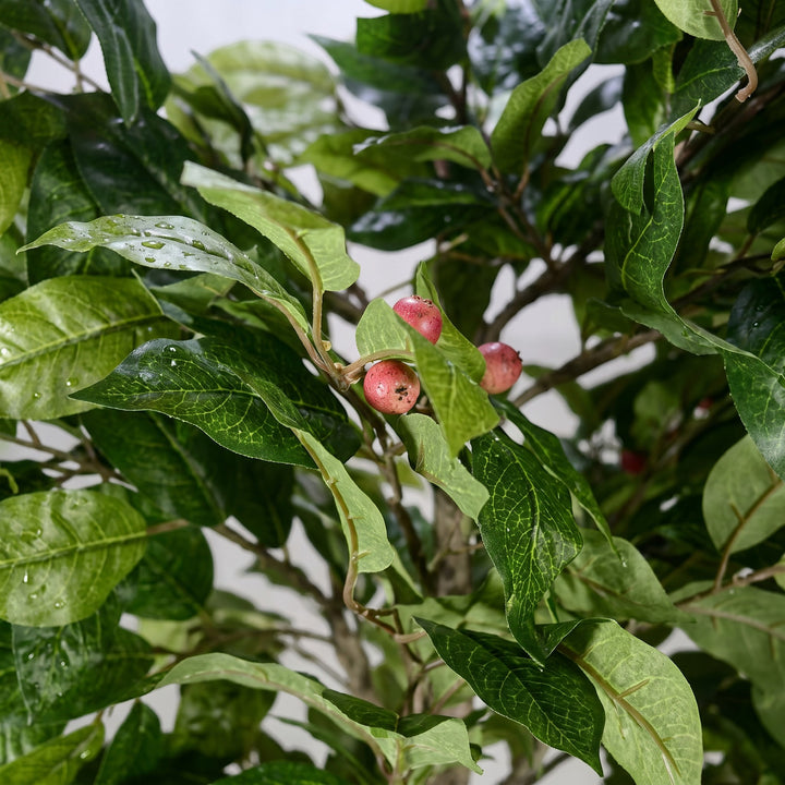 Wadi Home artificial potted tree with realistic green leaves and small red berries for indoor home decor.