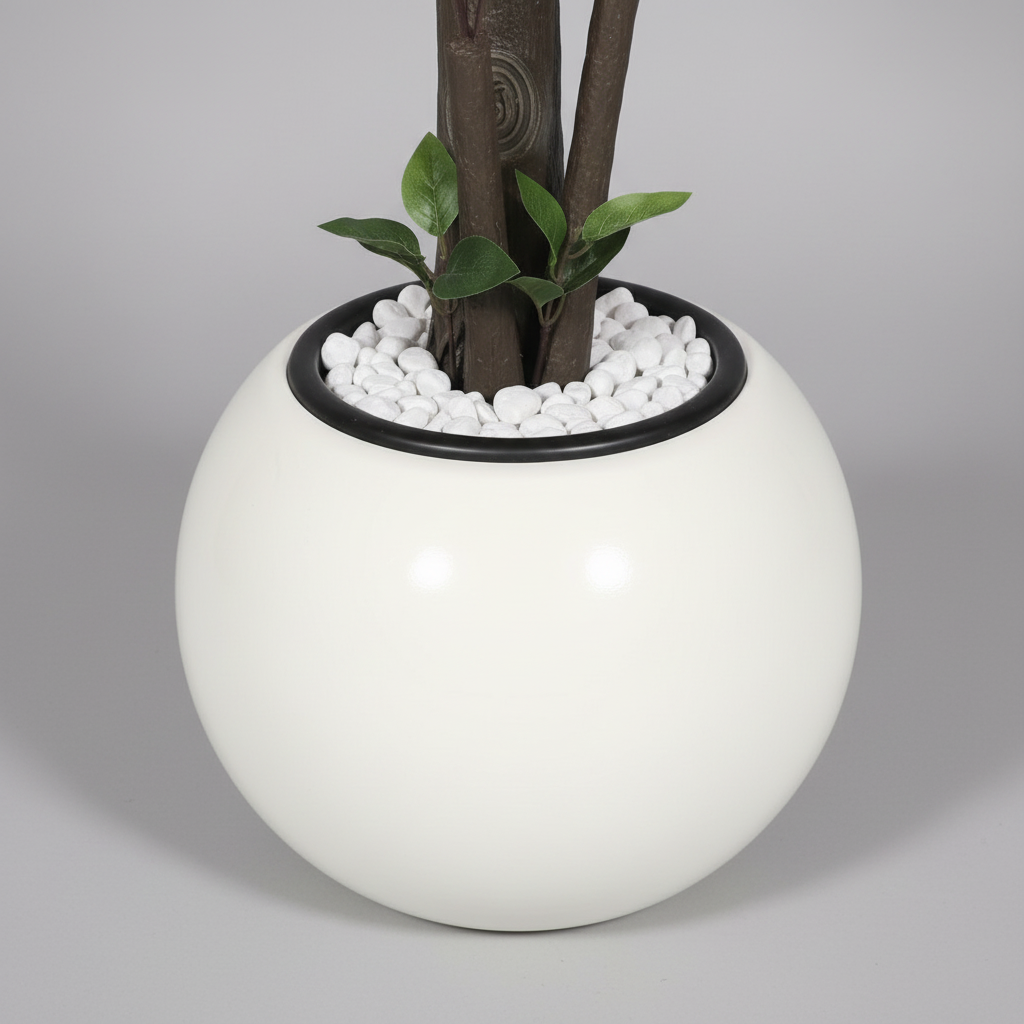 Wadi Home artificial tree in a modern white spherical planter with decorative white pebbles at the base