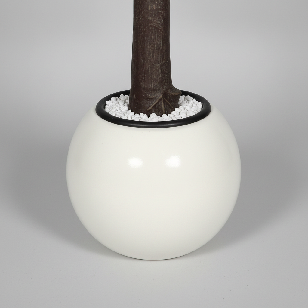 Wadi Home artificial flowering tree base featuring a textured brown trunk in a modern white spherical planter.