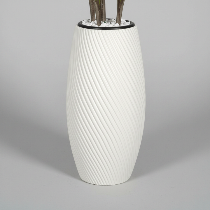 Wadi Home artificial yucca plant in a white textured spiral floor vase with decorative white stones at the base