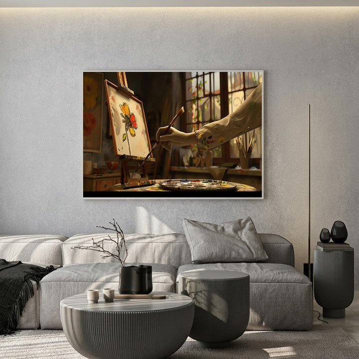Wadi Home artist studio painting wall art featuring a floral sketch on an easel in a sunlit room above a grey sofa.