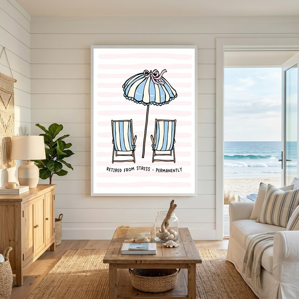 Wadi Home beach themed wall art print with striped chairs and umbrella on a pink background in a coastal living room.