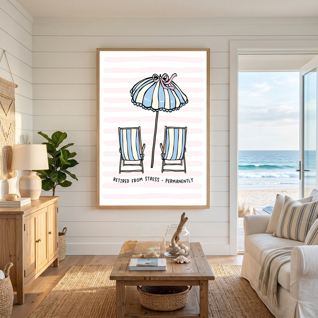 Wadi Home beach themed wall art print featuring striped chairs and umbrella on a pink background in a coastal living room