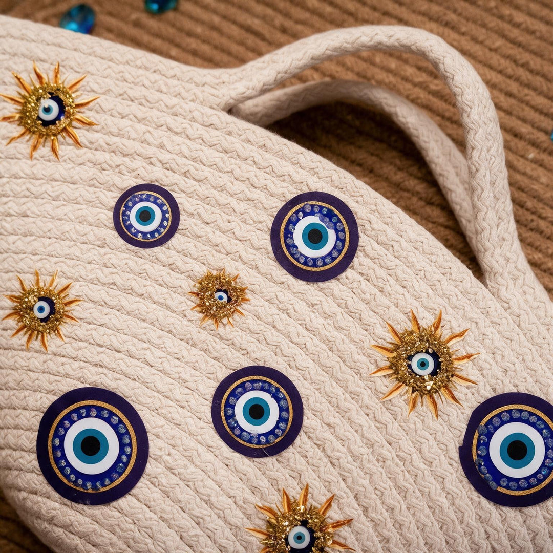 Wadi Home beige rope tote handbag featuring evil eye motifs and sun-inspired gold embellishments for a summer look.