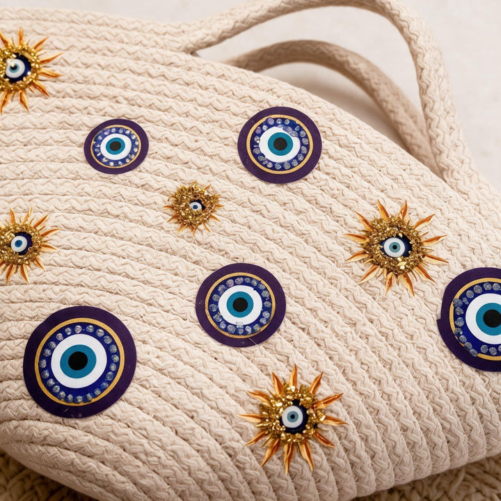Wadi Home beige rope tote handbag featuring evil-eye motifs and gold sun-inspired embellishments for a summer look.