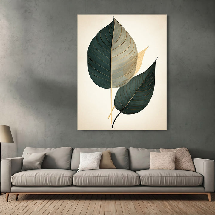 Wadi Home botanical leaf wall art print with teal and gold leaves on a cream background above a modern grey sofa.