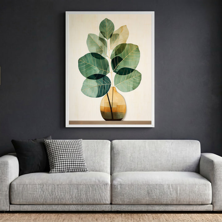 Wadi Home botanical plant wall art in a white frame hanging above a modern grey sofa in a minimalist living room.