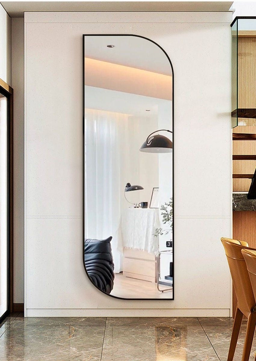 Wadi Home Brooklyn full length mirror with a modern arched black metal frame mounted on a white wall.