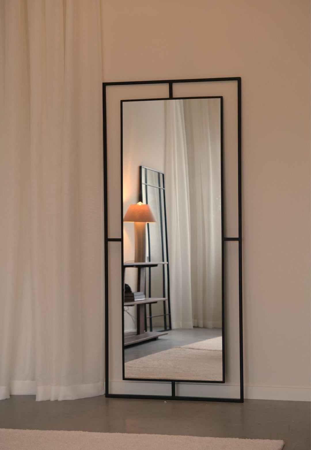 Wadi Home Brooklyn full length floor mirror with a sleek black metal frame standing in a minimalist living room