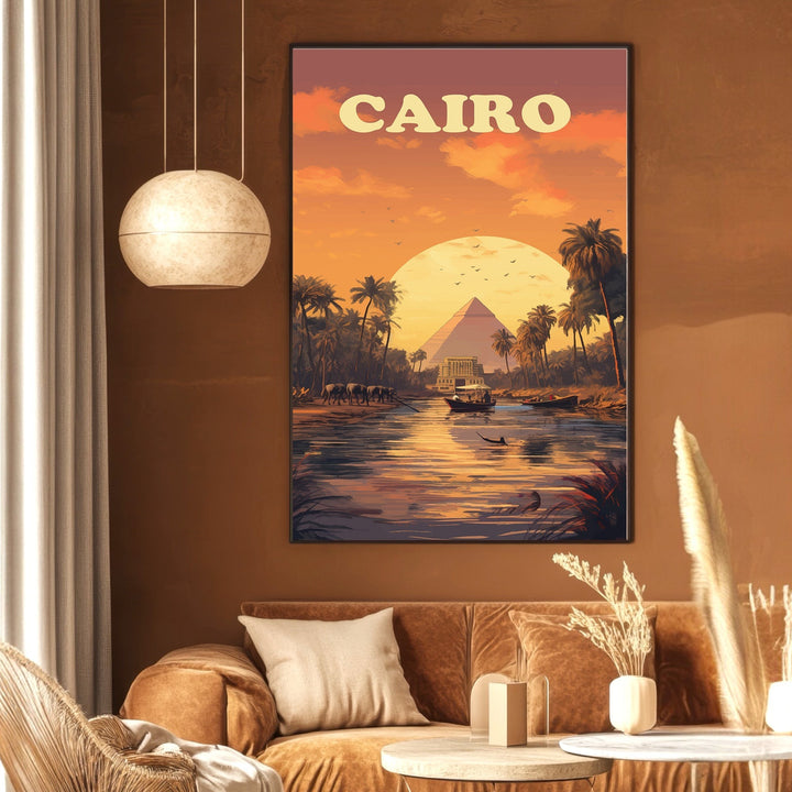 Wadi Home Cairo travel poster featuring pyramids and Nile River at sunset in warm orange and purple tones on a wall.