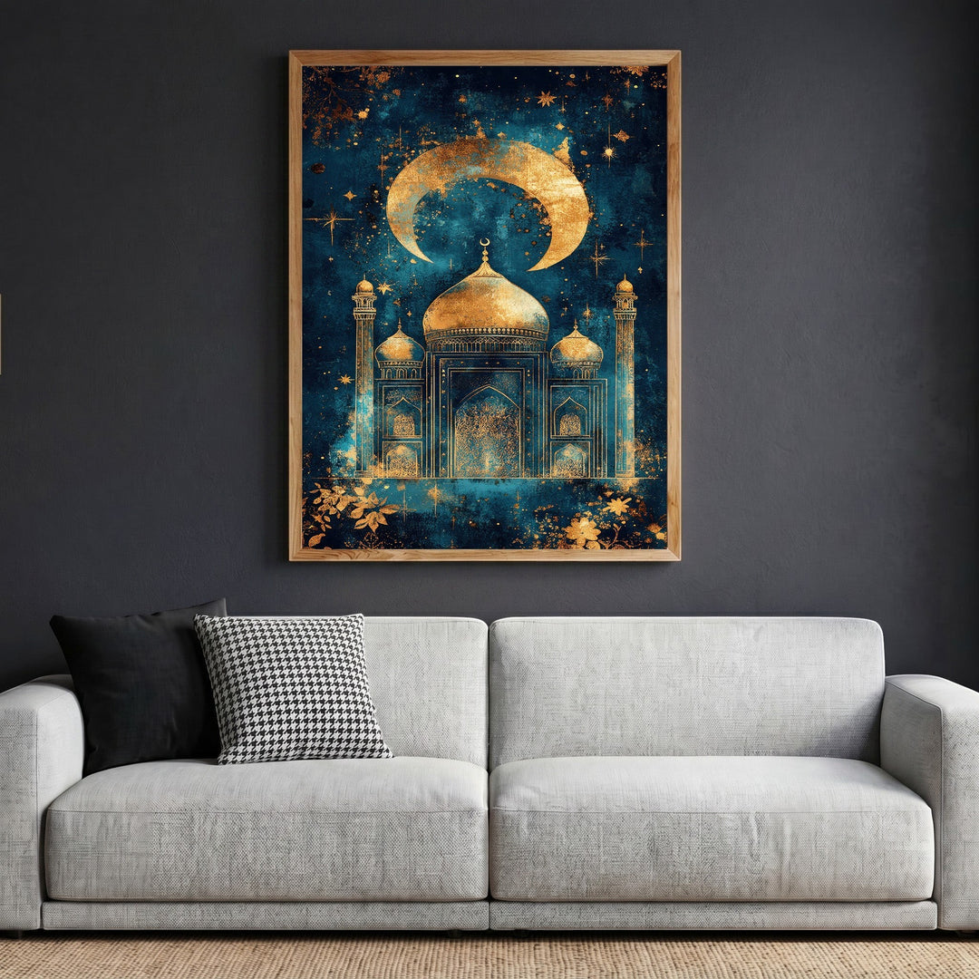 Wadi Home Celestial Mosque wall art print featuring a golden crescent moon and mosque silhouette on a midnight blue background, displayed in a wooden frame above a grey sofa.