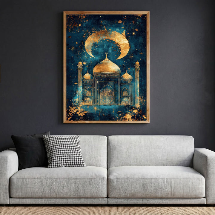 Wadi Home Celestial Mosque wall art print featuring a golden crescent moon and mosque silhouette on a midnight blue background, displayed in a wooden frame above a grey sofa.