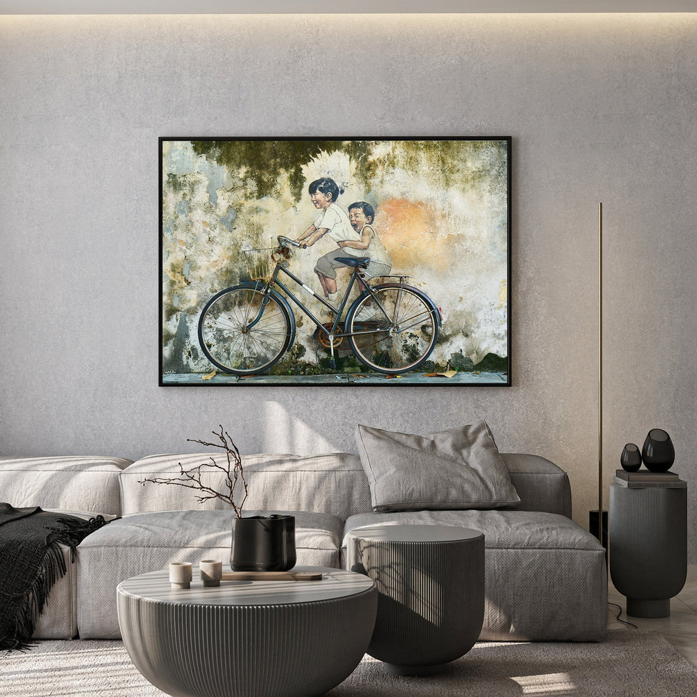 Wadi Home wall art print featuring children on a vintage bicycle against a textured wall in a modern living room