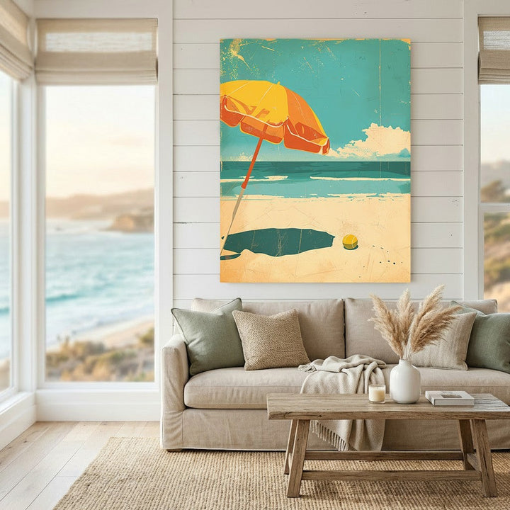 Wadi Home coastal beach scene framed wall art with a yellow umbrella on a blue ocean background in a living room.