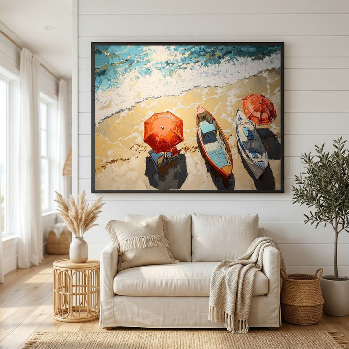 Wadi Home coastal beach scene framed wall art with colorful boats and umbrellas hanging above a beige living room sofa.