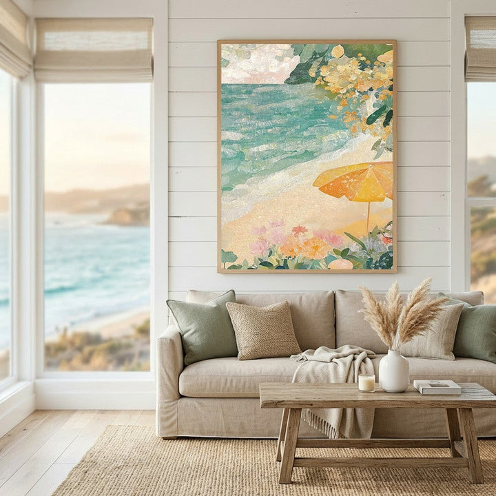 Wadi Home coastal beach scene framed wall art featuring turquoise ocean, yellow umbrella, and flowers above a sofa.