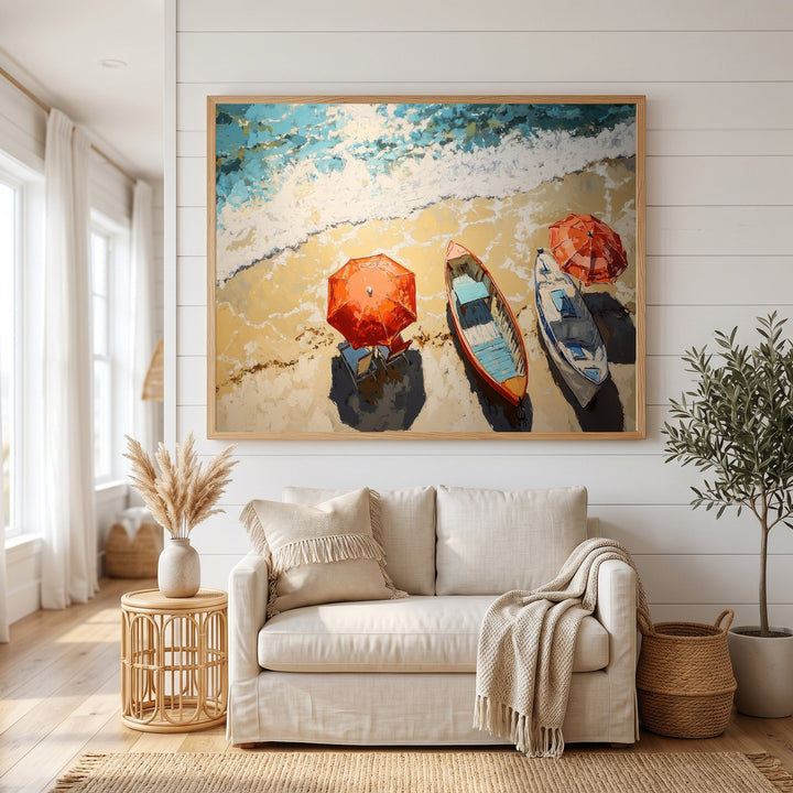 Wadi Home coastal beach scene framed wall art with colorful boats and umbrellas hanging above a beige living room sofa.