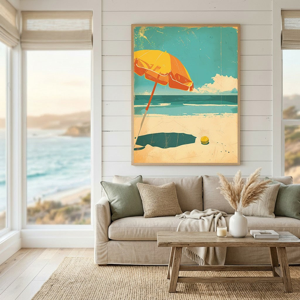 Wadi Home framed coastal beach art print featuring a yellow umbrella on a sandy shore above a neutral living room sofa.