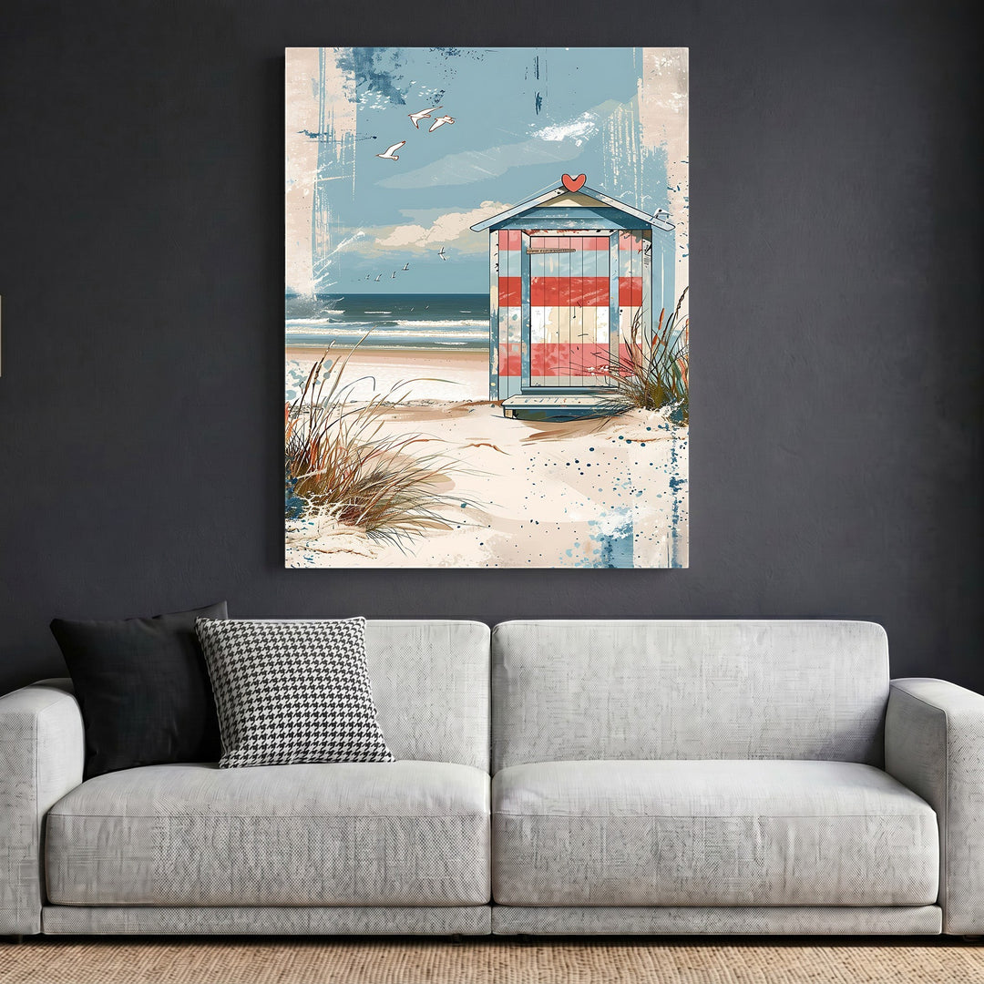 Wadi Home coastal beach house framed wall art featuring a striped hut on dunes above a modern grey sofa.